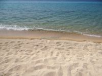 Fluffy sand and crystal clear waters of on the beach of Toroni
