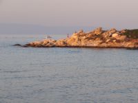 The rocks in Karydi beach in Vourvourou, bathed in the light of the setting sun
