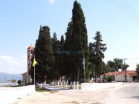 Cypress trees in front of the church in the village Pontismeno in Serres