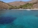 Clear blue waters and tamarisk trees on the beach Gria Spilia in northern Syros